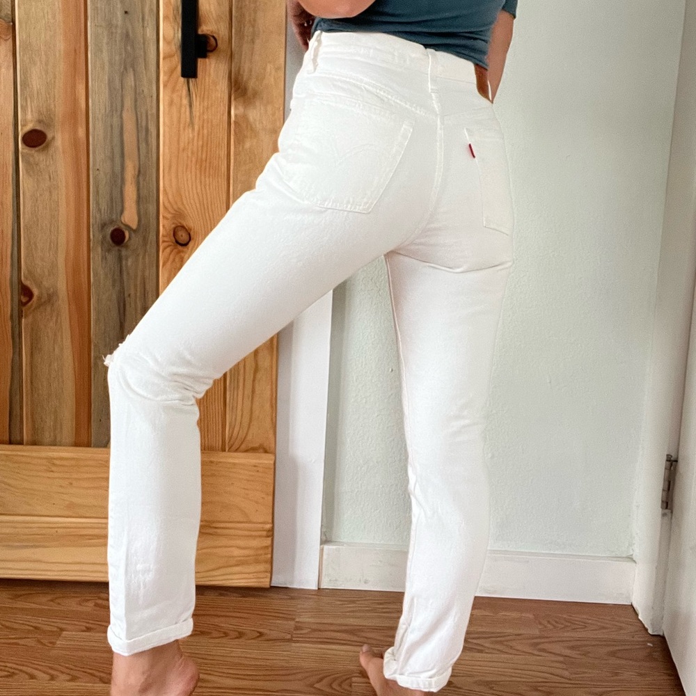 LEVIS PREMIUM QUALITY DENIM 501 IN WHITE WITH SOME DISTRESSING.